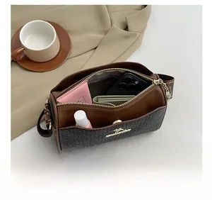 Interior view showing large capacity for essentials in the brown Boston pillow bag