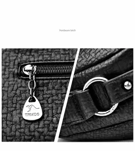 Détail de la fermeture éclair en métal argenté sur le sac en cuir noir à grain galet