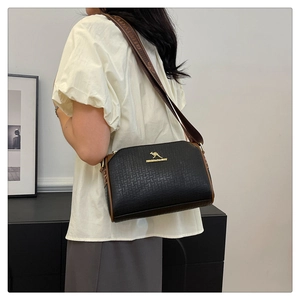 Detail of black pebbled leather Boston bag with gold kangaroo logo and wide strap