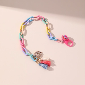 Detail of colorful plastic chain strap with sea shell, tassels and beaded flower charm
