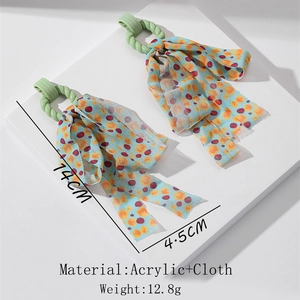 Detailed size view of bohemian long tassel earrings with acrylic ring and floral fabric