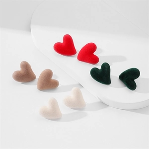 Detail of S925 silver needle heart studs with soft flocked texture in multiple colors