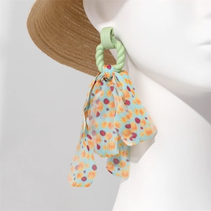 Detail of mint green spiral ring with long printed blue chiffon tassel on white mannequin