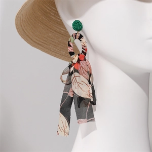 Detail of long floral chiffon tassel earrings with green beads and fabric wrapped hoop