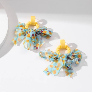 Macro shot of large light blue chiffon bow earrings with yellow resin rings for party