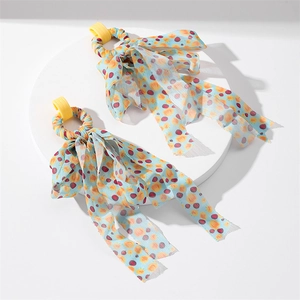 Close-up of floral print fabric tassels on long elegant dangle drop earrings