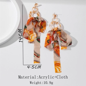Close-up of long chiffon tassel earrings with orange fruit print and acrylic link