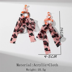 Detail of 14cm long fringe earrings with acrylic rings and leopard chiffon bow