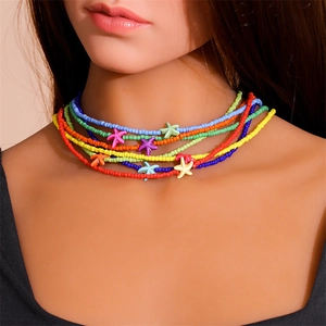 Colorful bohemian multilayer beaded necklace featuring starfish pendants on a model