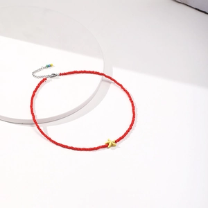 Detail of red bead choker necklace with yellow starfish pendant and adjustable silver chain