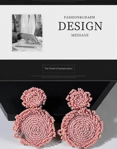 Macro shot of pink handmade beaded earrings with intricate layered floral texture