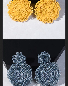 Detailed macro view of yellow and grey handmade woven seed bead earrings in boho style
