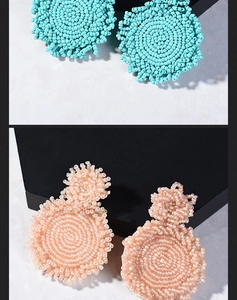 Detail of bohemian handmade beaded hoop earrings in turquoise and peach pink styles