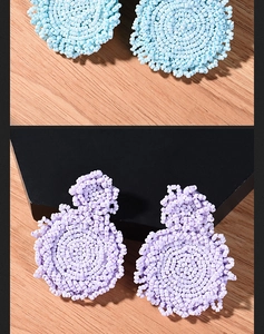 Detailed texture of bohemian hand-woven beaded earrings in blue and purple styles