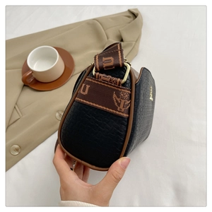 Detail of black embossed leather Boston bag with vintage jacquard woven shoulder strap