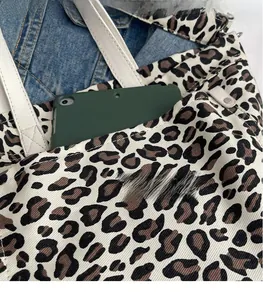 Close-up of leopard print canvas tote bag showing interior space for a tablet device