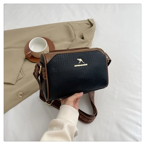 Detail of Boston bag with textured black PU leather, brown stitching and golden hardware
