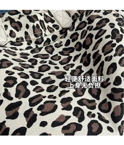 Detail of leopard print tote bag showing diagonal twill texture and sturdy white stitching
