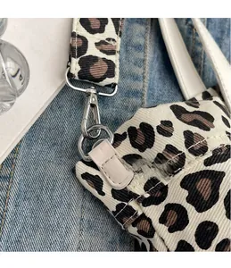 Detailed view of leopard print canvas tote with high-quality silver metal hook attachment
