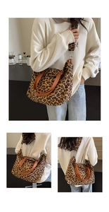 Detail of leopard print canvas tote bag with brown leather handles and wide shoulder strap