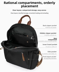 Detail view of the multi-compartment interior layout in a black nylon backpack