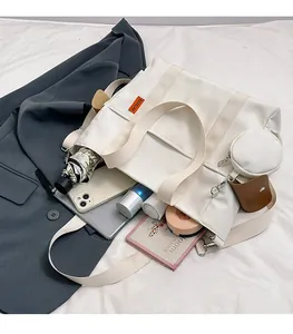 Detail of white canvas tote bag with spacious interior compartments for gadgets