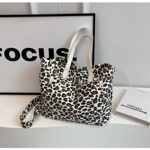 Detailed view of leopard print canvas tote bag with shoulder strap and sturdy handles