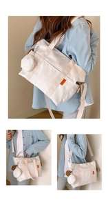 Detail of white large capacity tote bag with adjustable strap and small round coin purse