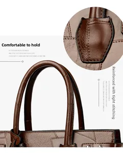Detail of brown faux leather tote bag with reinforced handles and precise stitching