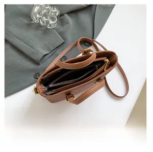 Interior view of brown pebble leather bucket bag showing multi-compartment storage space