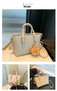 Macro view of khaki bucket bag with lychee grain texture and gold hardware detail