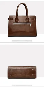 Detail view of brown patchwork tote bag showing rear zipper pocket and metal bottom studs