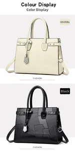 Close-up of geometric paneled tote bag with metal charm in black and beige colors