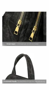 Detalle de las cremalleras dobles doradas y el asa de tela suave del bolso de pecho negro para mujer