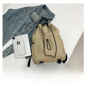 Detail view of khaki waterproof nylon drawstring backpack with reinforced straps and cords