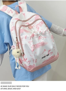 Détail latéral d'un sac à dos floral pour filles avec pendentif en peluche et motif frais