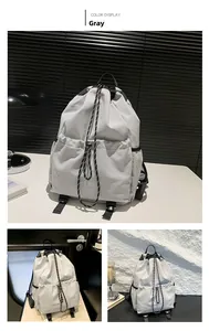 Detail view of a light gray waterproof drawstring backpack with textured decorative ropes