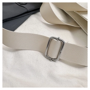 Detail of adjustable off-white canvas strap with premium silver metal buckle