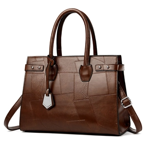 Dark brown patchwork leather tote bag with geometric panel design and top handles