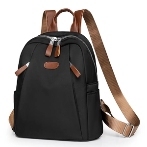 Classic black nylon backpack for women with brown leather accents and metal buckles