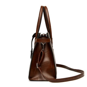 Brown leather拼接 tote bag with dual handles and adjustable shoulder strap, side view