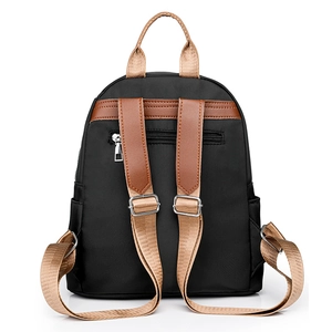 Minimalist black nylon backpack with brown leather straps and back anti-theft zipper pocket