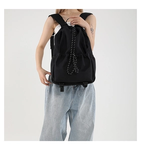 Detail of waterproof nylon drawstring backpack with sporty black and white rope accents