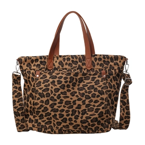 Large leopard print canvas tote bag with brown leather handles and adjustable shoulder strap