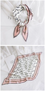 Close-up of pleated silk scarf featuring elegant horsebit chain pattern in pink and grey