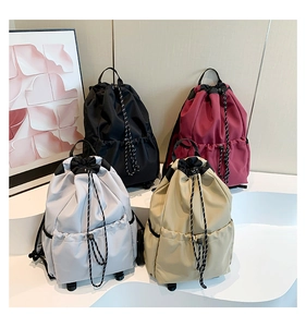 Four colors of waterproof nylon drawstring backpacks shown in a tiered display