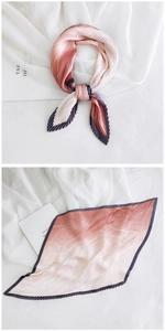 Detail of pink and beige gradient pleated silk scarf with dark contrast edges