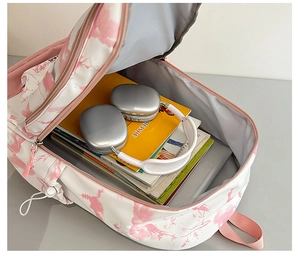 Vue détaillée du grand compartiment intérieur avec livres et écouteurs dans le sac à dos