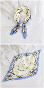 Detail of pleated silk scarf with retro chain print in light blue and beige colors