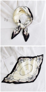 Detail of pleated silk scarf with vintage chain patterns in black, white, and soft pink